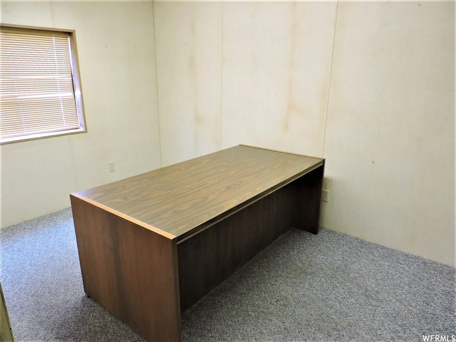 Office with dark colored carpet