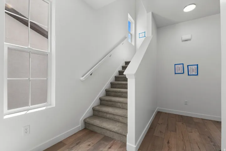 Stairs featuring wood-type flooring and baseboards