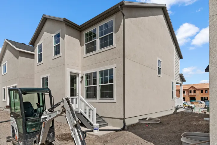 Back of house featuring stucco siding