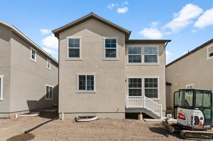 Rear view of house with stucco siding