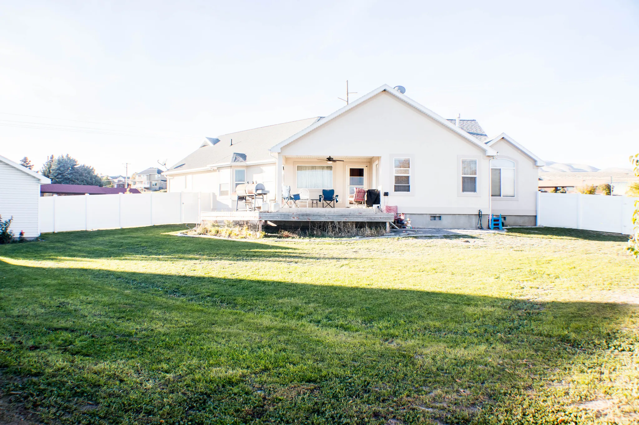 Rear view of property featuring a fenced backyard and ceiling fan