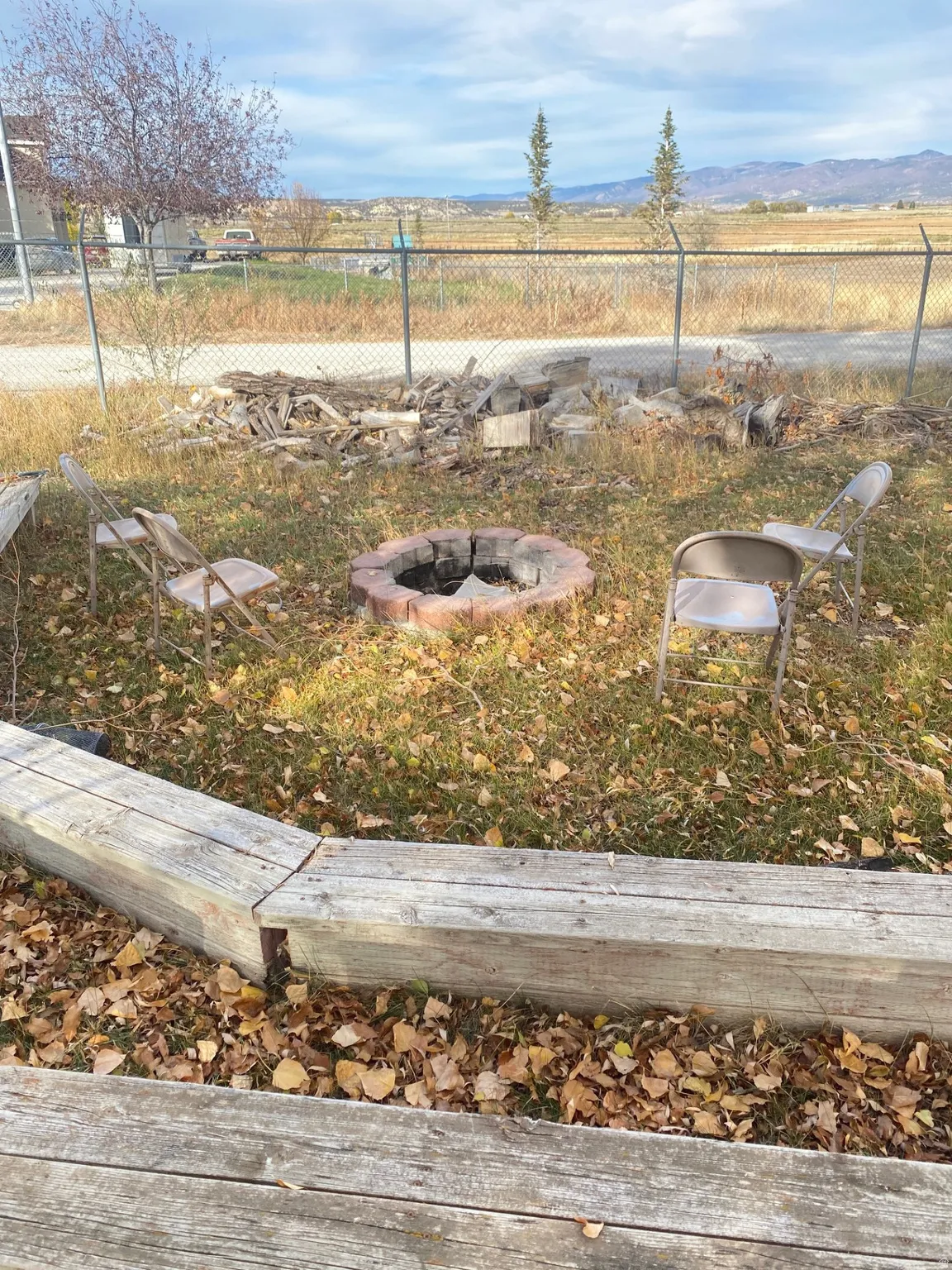 View of yard with an outdoor fire pit and a mountain view