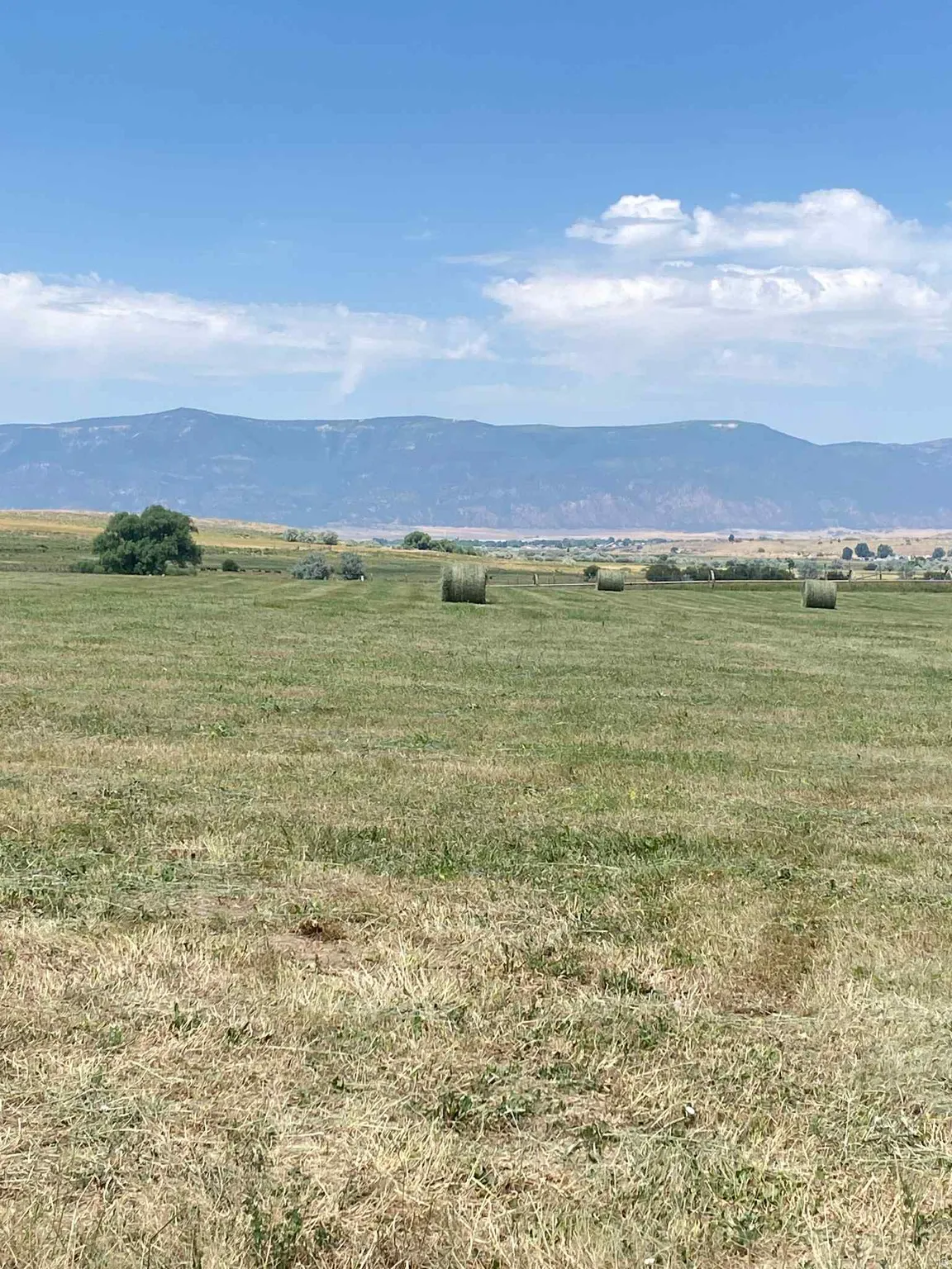 View of mountain backdrop featuring rural landscape