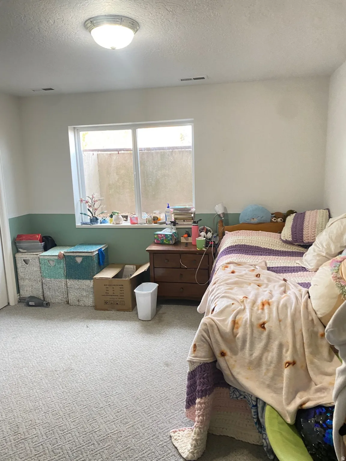 Carpeted bedroom with a textured ceiling