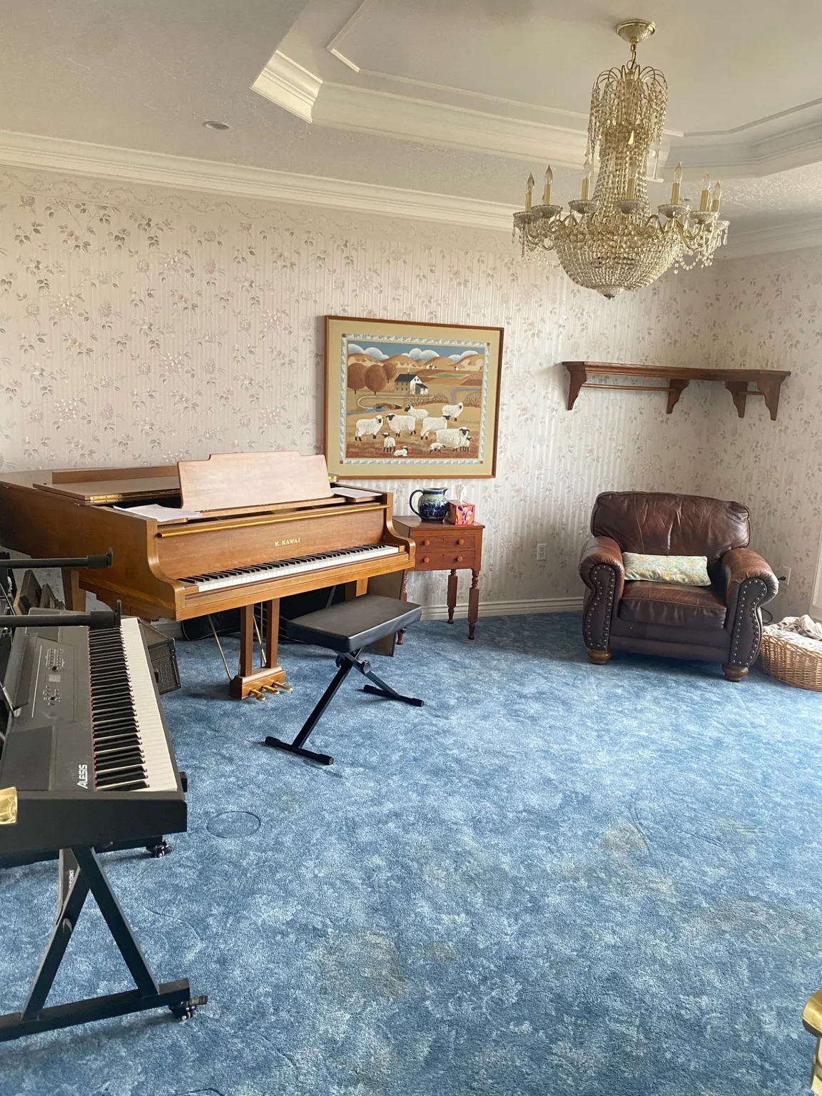 Carpeted office featuring wallpapered walls, ornamental molding, a chandelier, and a tray ceiling