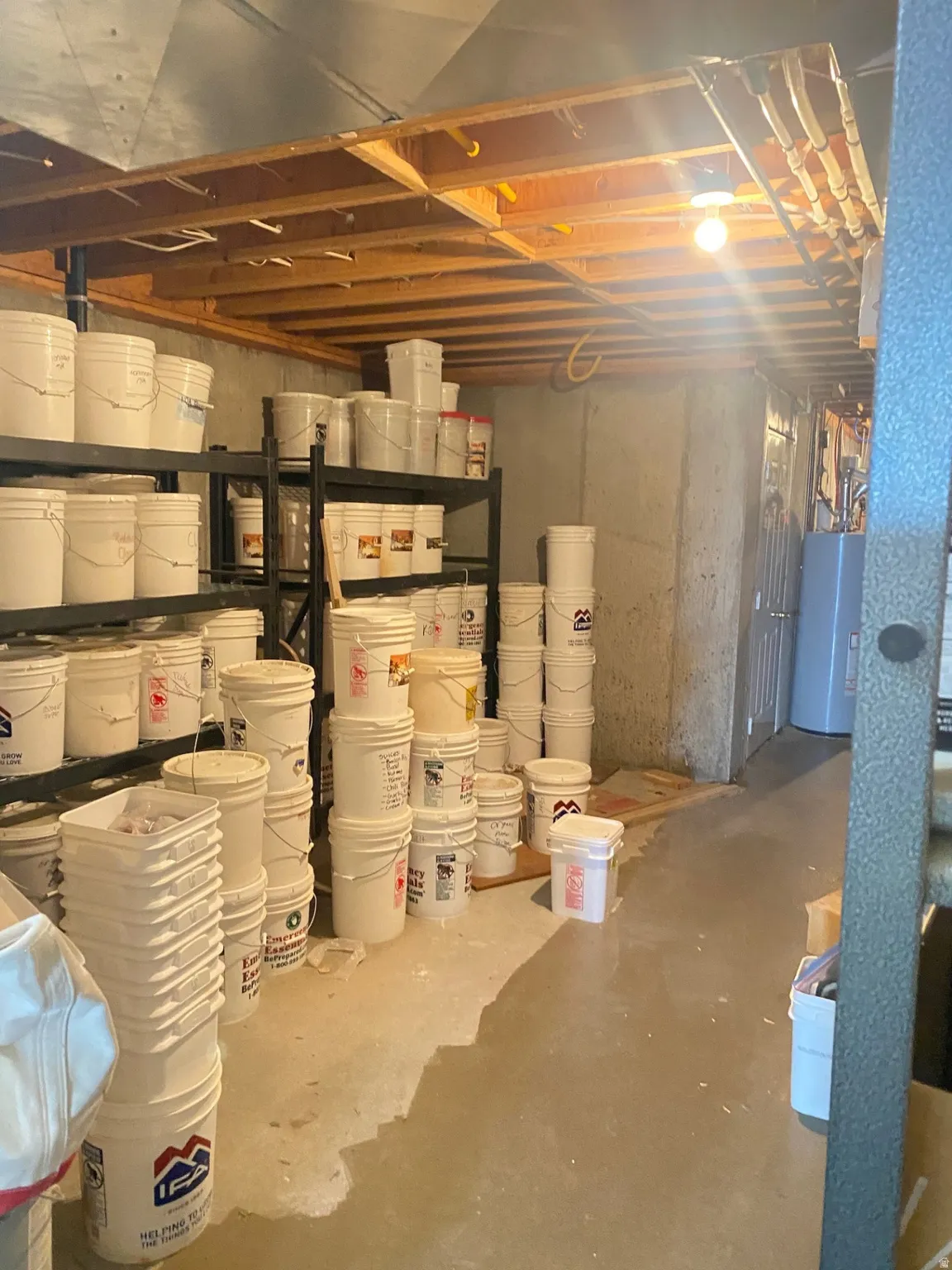 Unfinished basement featuring water heater