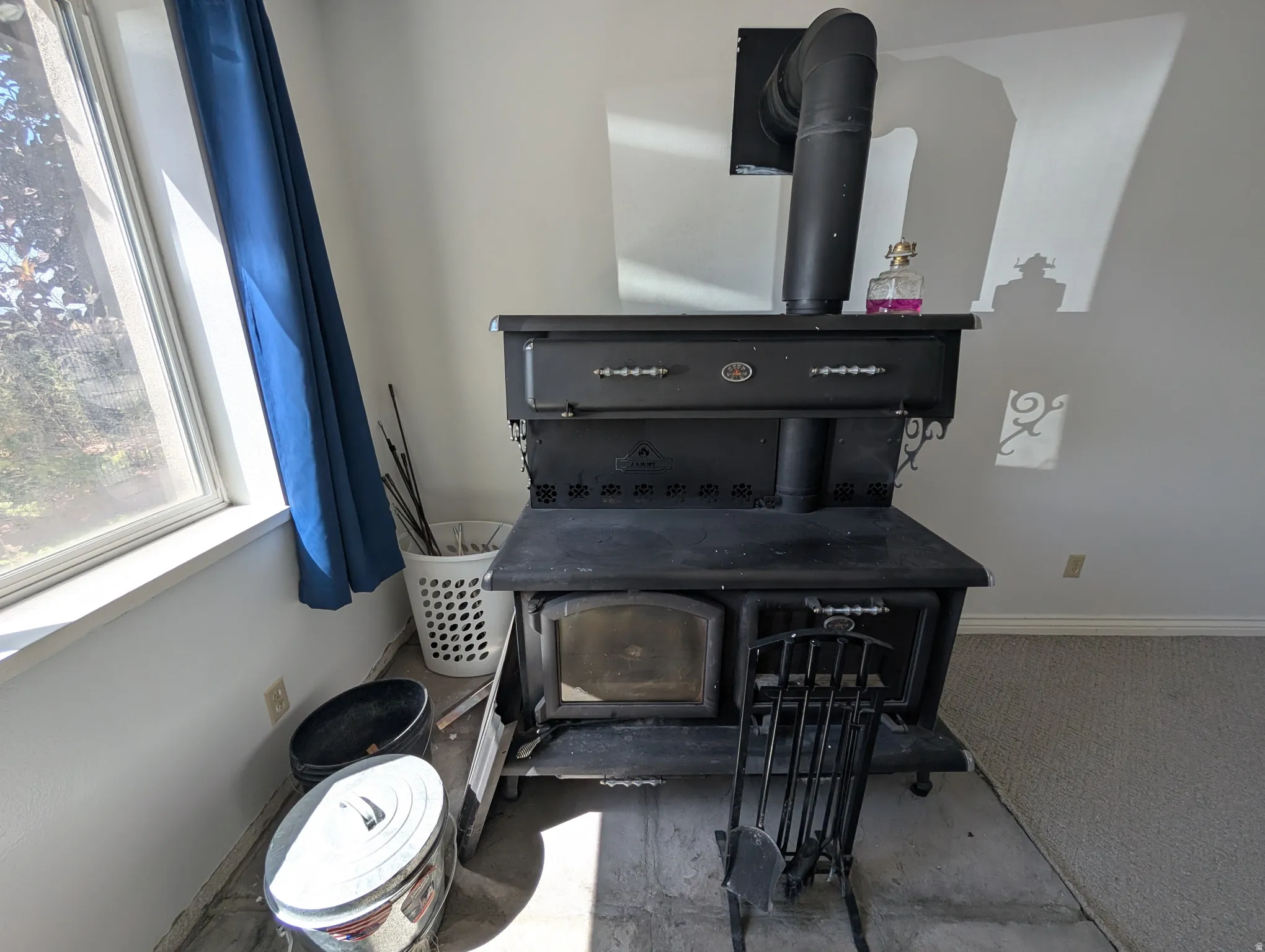 Detailed view of a wood stove and carpet