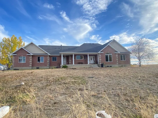 Ranch-style home featuring brick siding, a porch, and crawl space