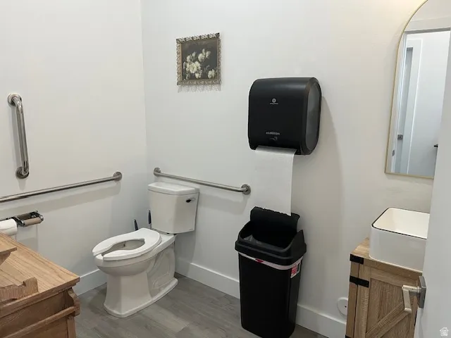 Half bath featuring vanity and light wood-type flooring