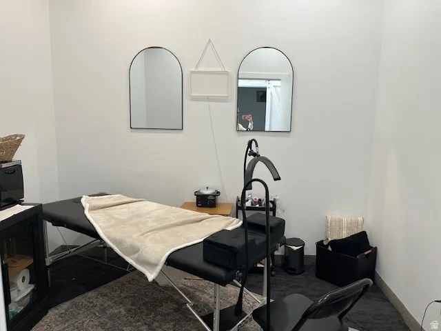 Bedroom featuring dark colored carpet