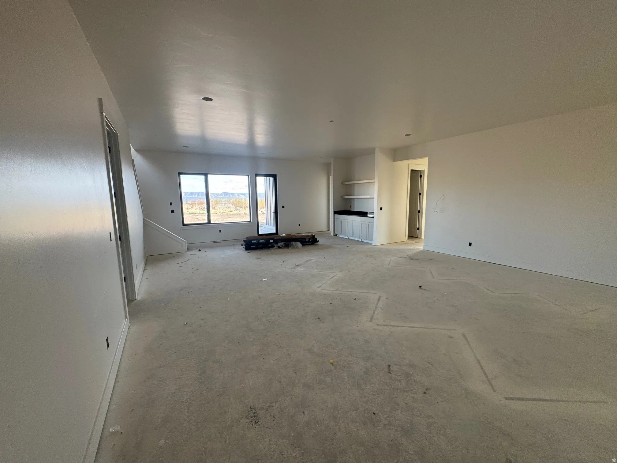 Unfurnished living room with baseboards