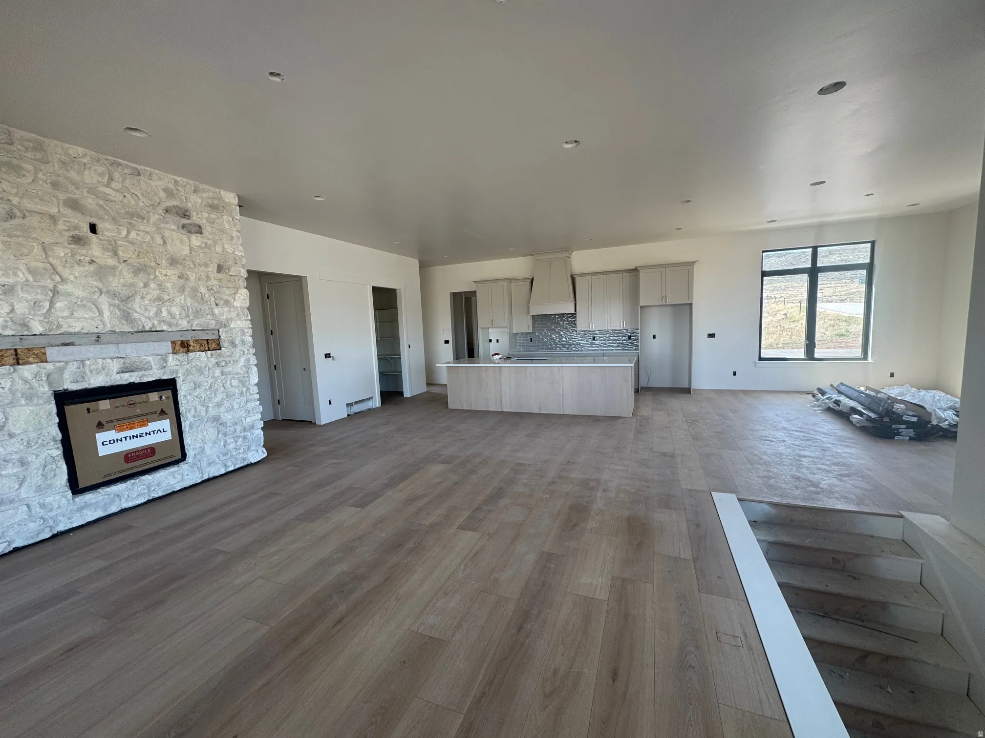 Unfurnished living room featuring a fireplace and dark wood-type flooring