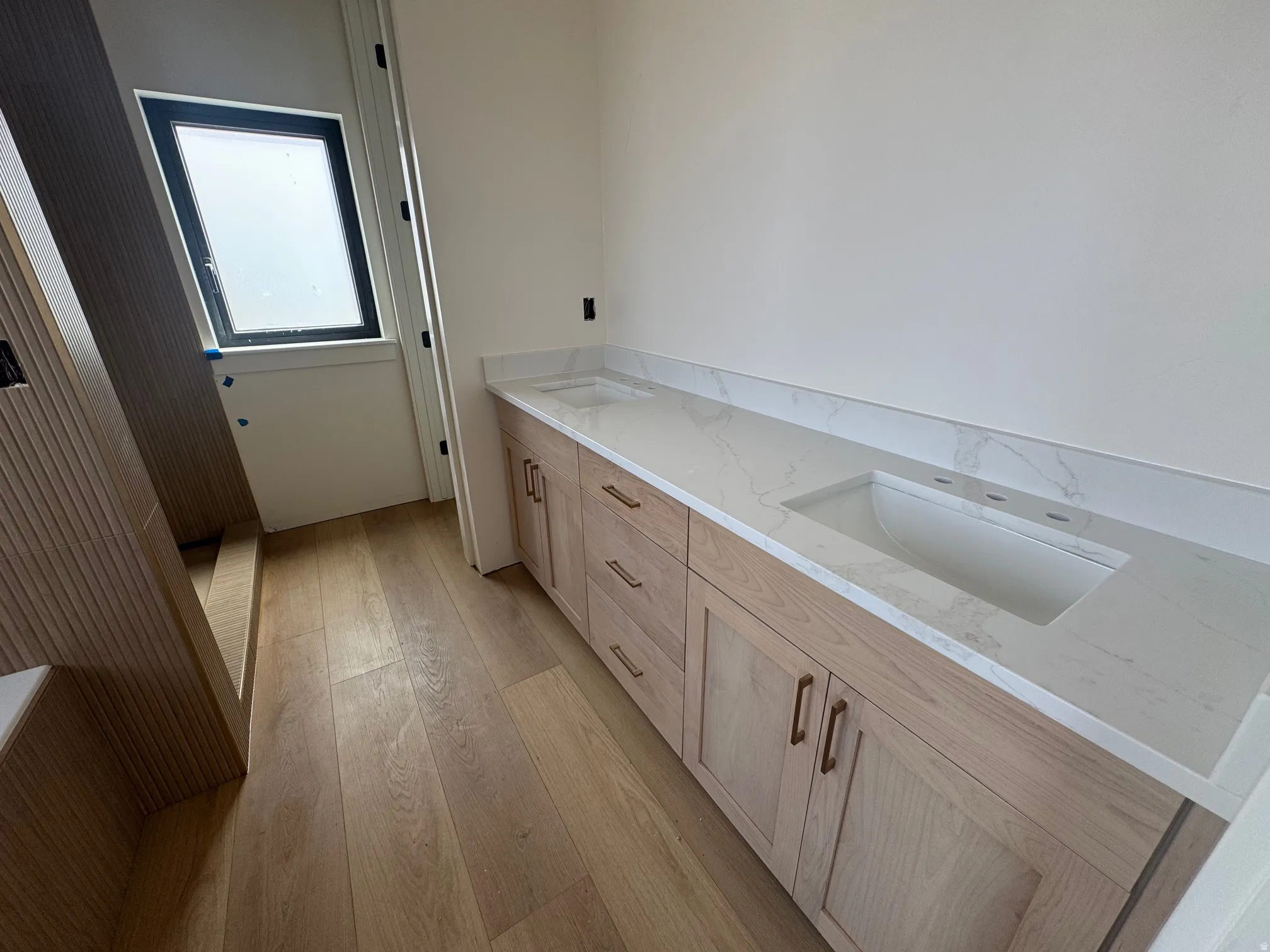 Laundry room featuring light wood finished floors and a sink
