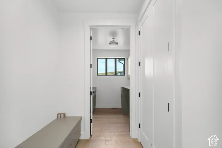 White interior walls with a built-in storage bench featuring drawers
