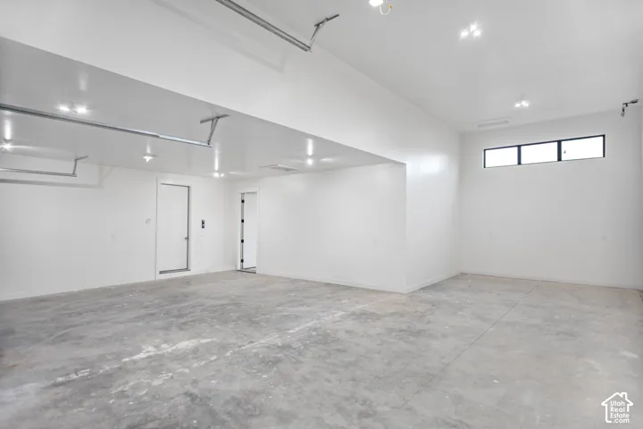 Polished concrete flooring, recessed lighting, multiple entryways, and a high-set window