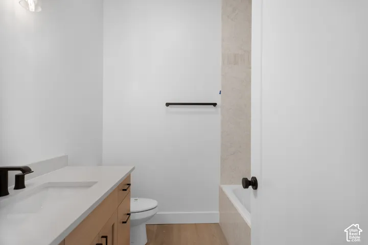 Light wood-finish vanity with a white countertop and integrated sink