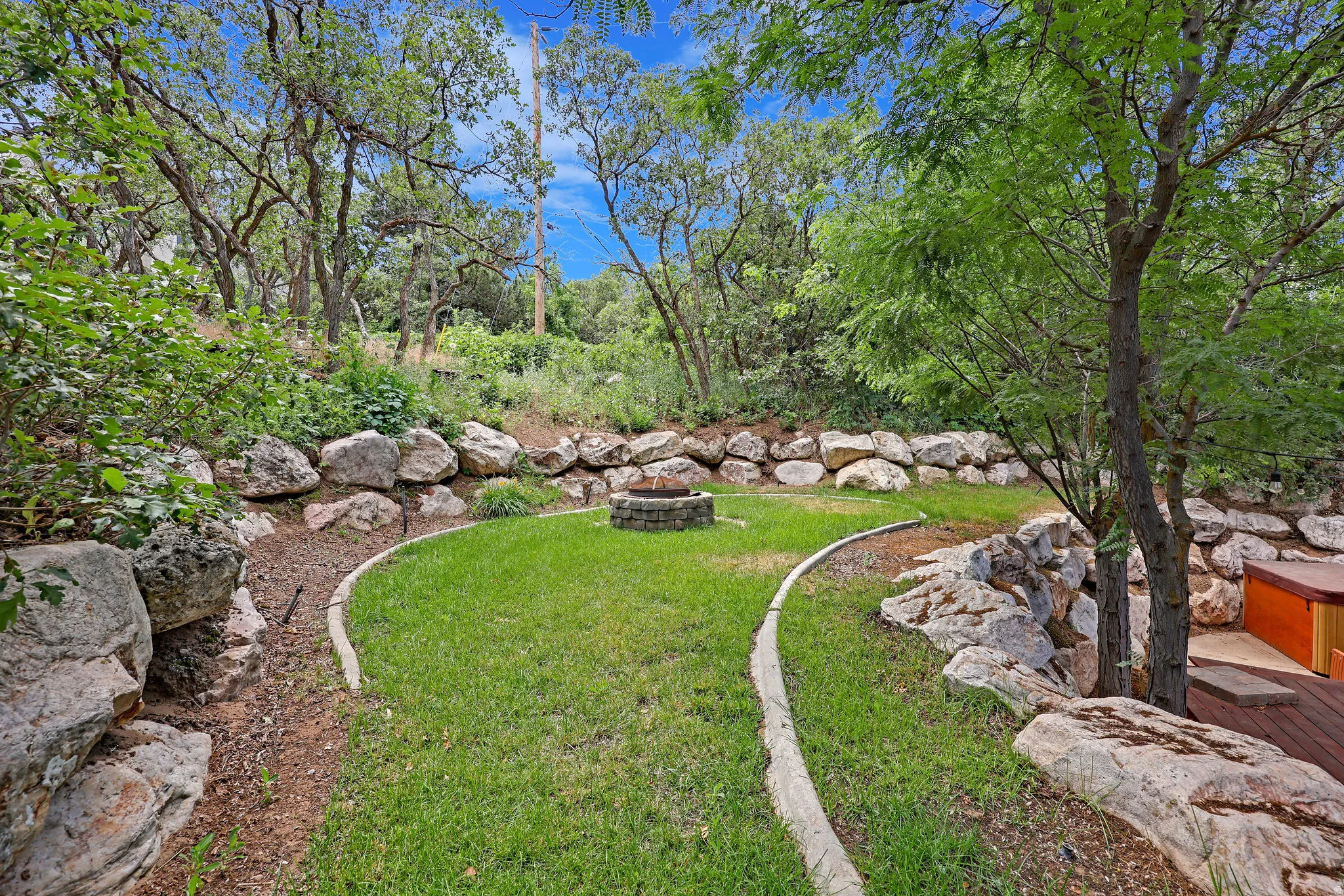View of green lawn featuring a fire pit