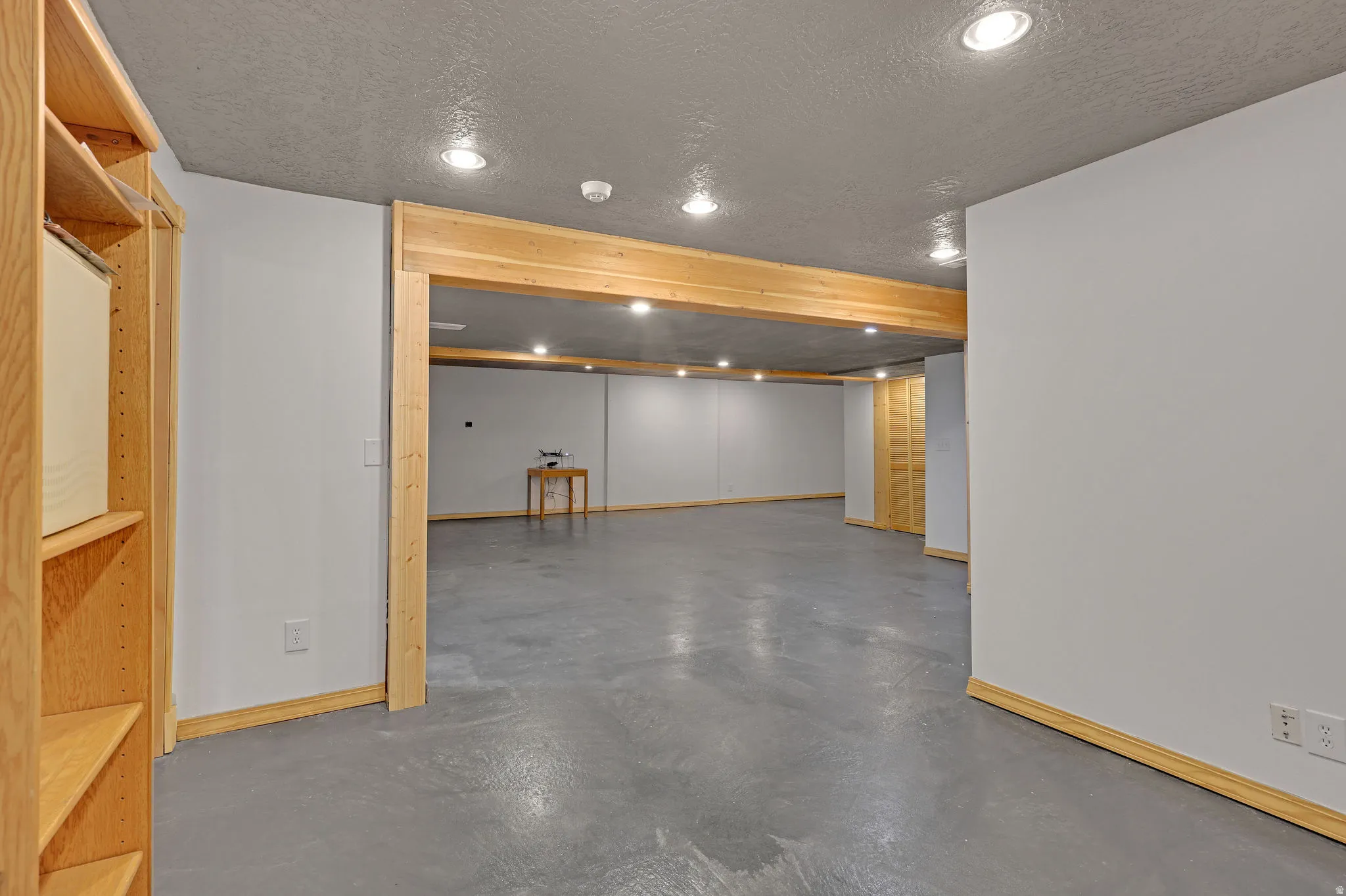 Finished below grade area with a textured ceiling and recessed lighting