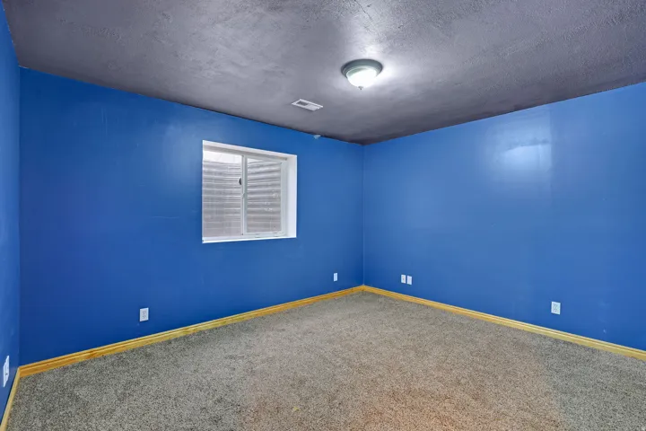 Spare room featuring a textured ceiling and carpet floors