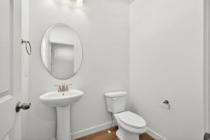 Bathroom with wood finished floors and baseboards