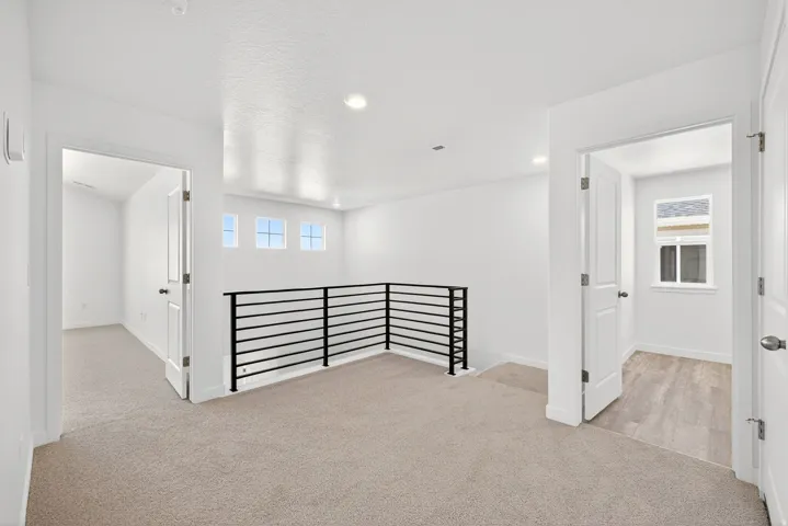 Empty room featuring light carpet, recessed lighting, and a textured ceiling