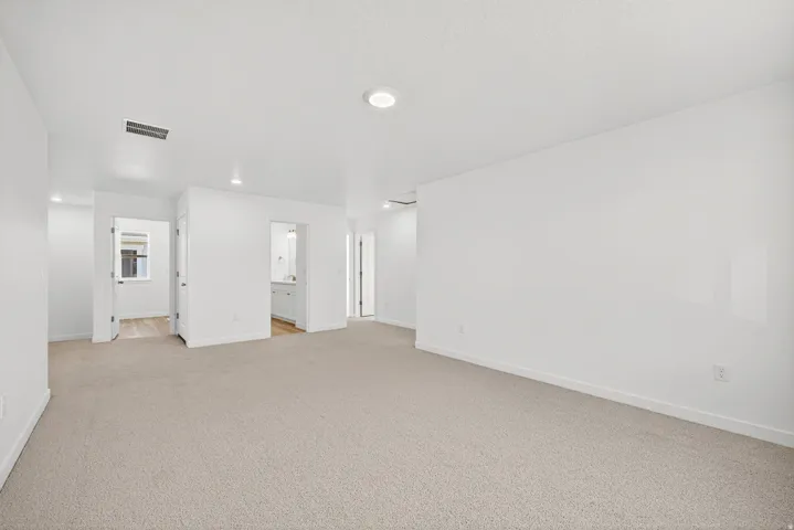 Empty room featuring light carpet and recessed lighting