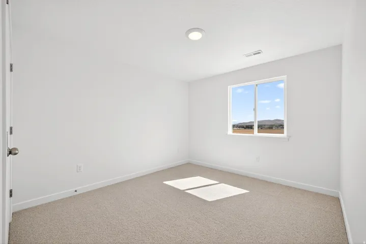 Carpeted empty room featuring baseboards