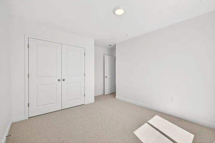 Unfurnished bedroom with carpet floors and a closet