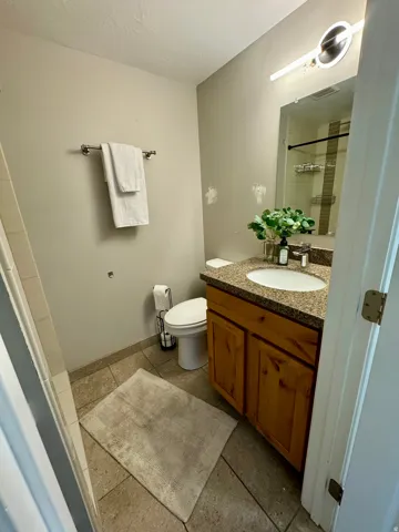 Full bath with vanity and a shower