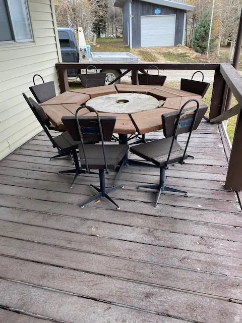 Deck featuring outdoor dining area and an outbuilding
