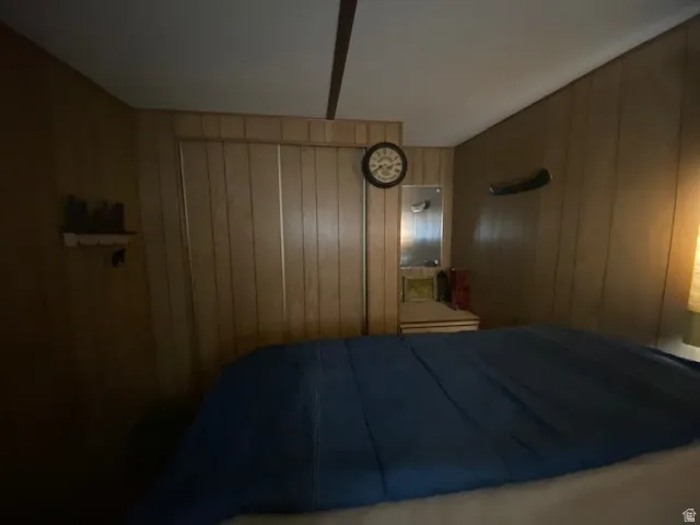 Bedroom with wooden walls