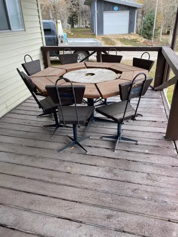 Deck featuring outdoor dining area and an outbuilding