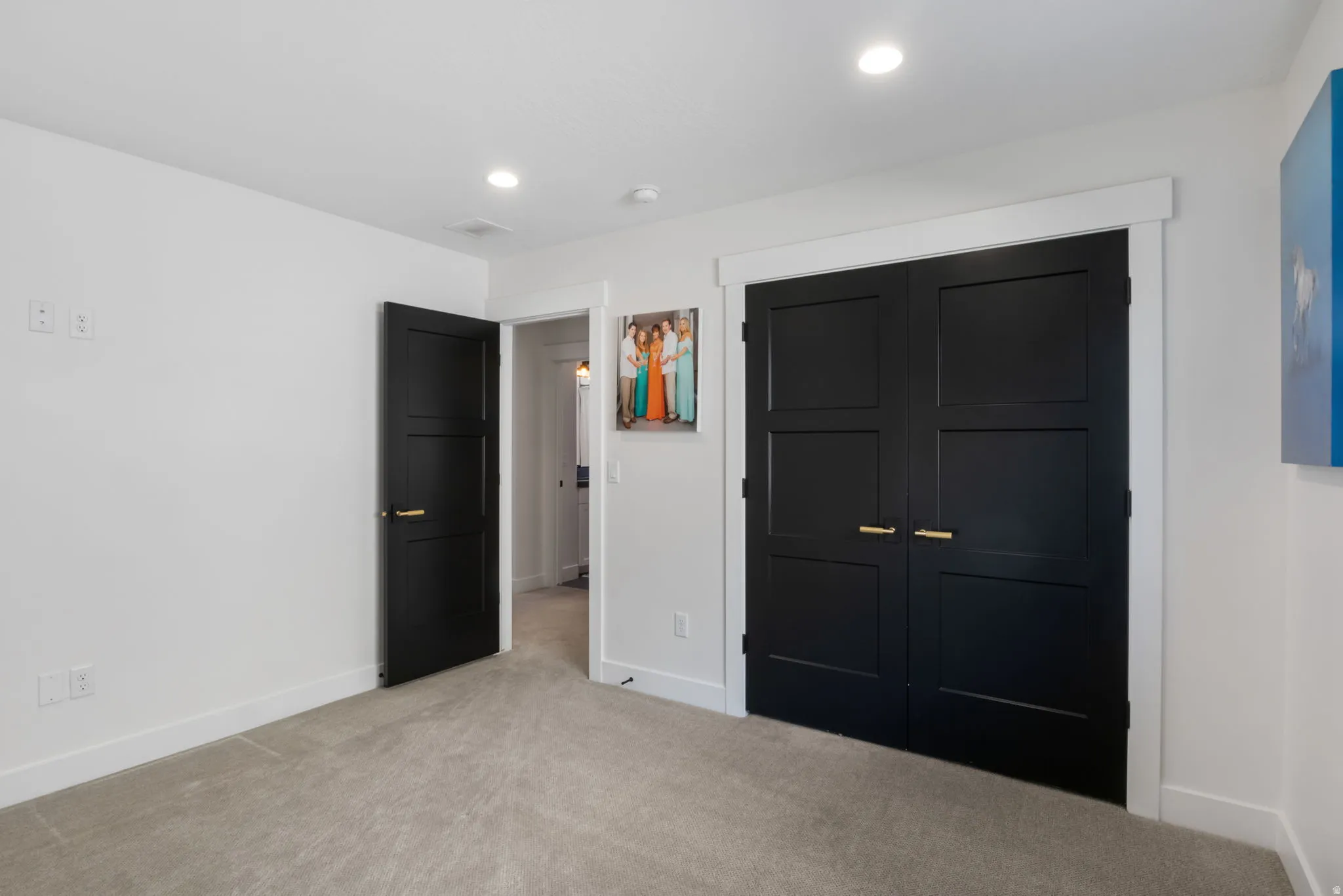 Unfurnished bedroom featuring light colored carpet, a closet, and recessed lighting