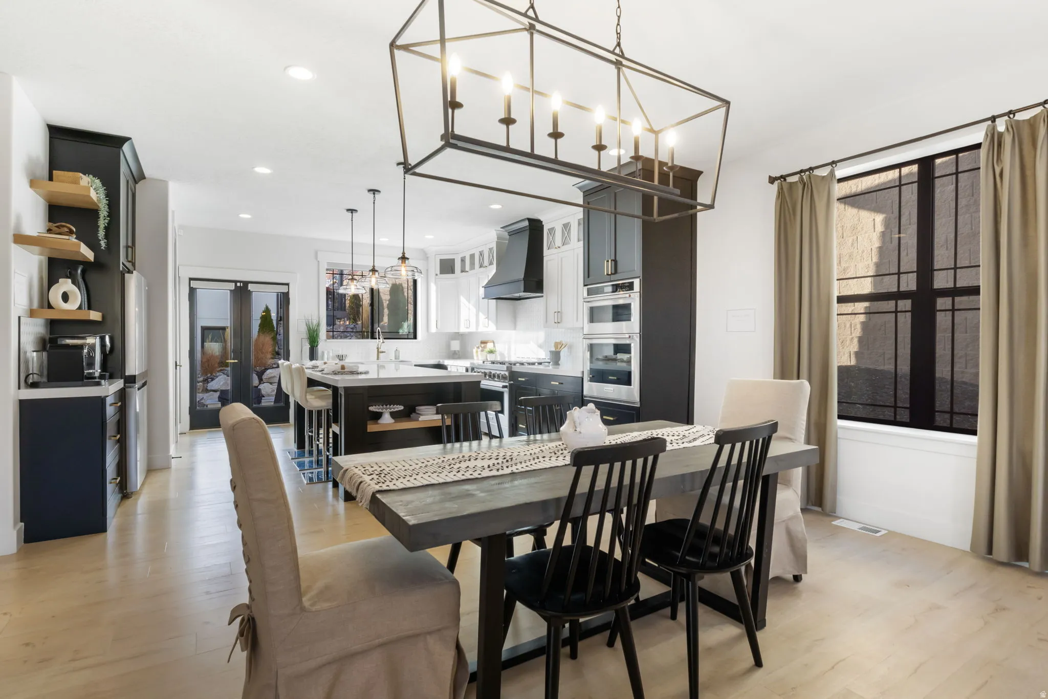 Dining area featuring light wood-style flooring, a chandelier, recessed lighting, and french doors