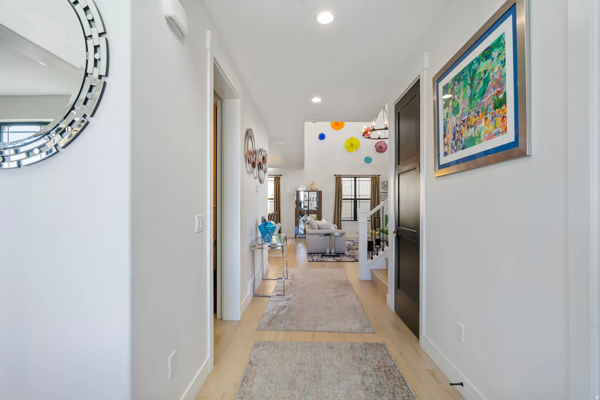 Corridor with stairs, recessed lighting, and light wood finished floors