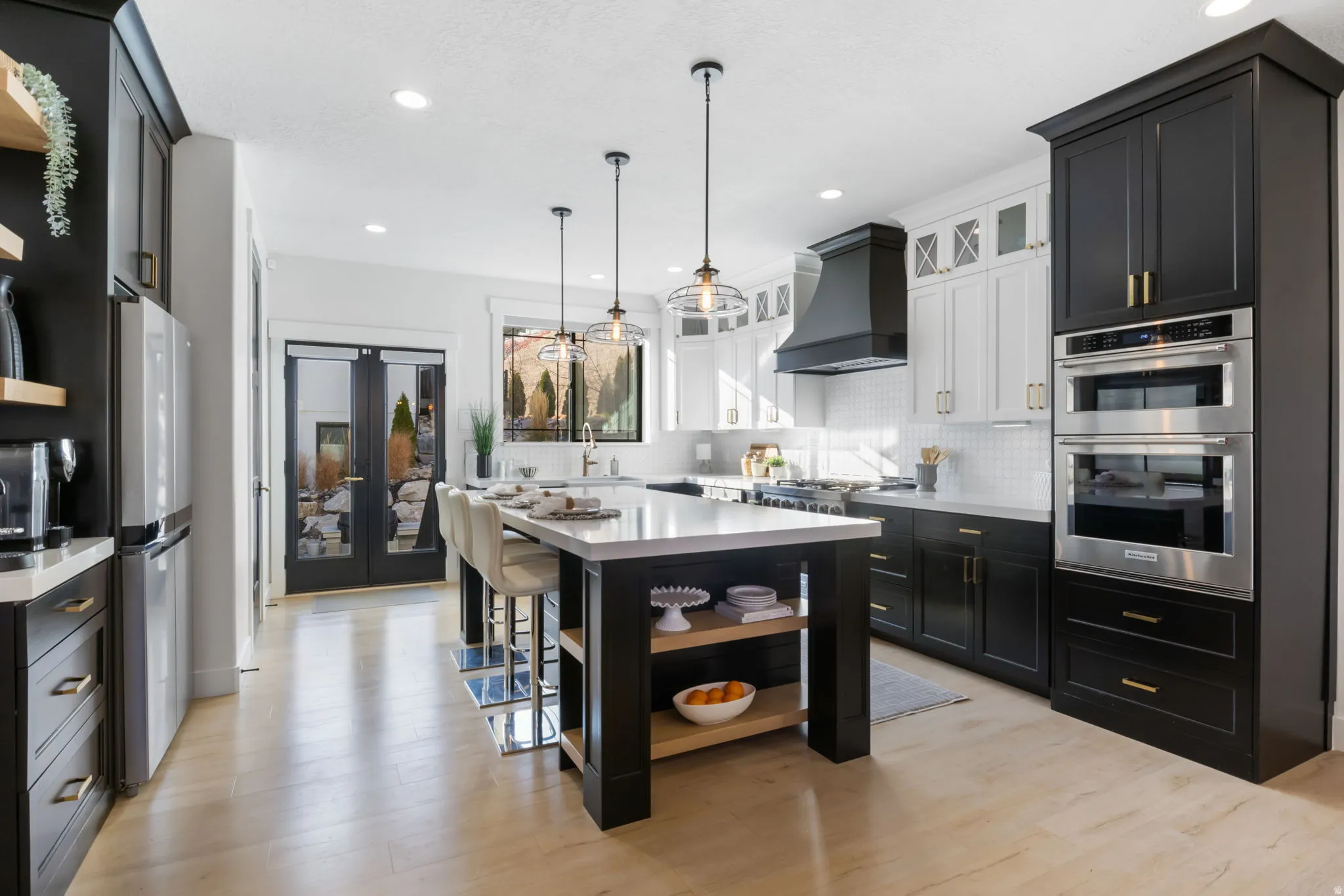 Kitchen featuring open shelves, dark cabinets, decorative light fixtures, glass insert cabinets, and recessed lighting