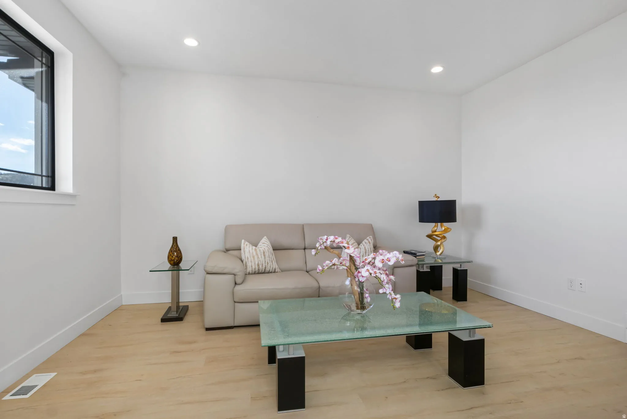 Living room featuring light wood finished floors and recessed lighting