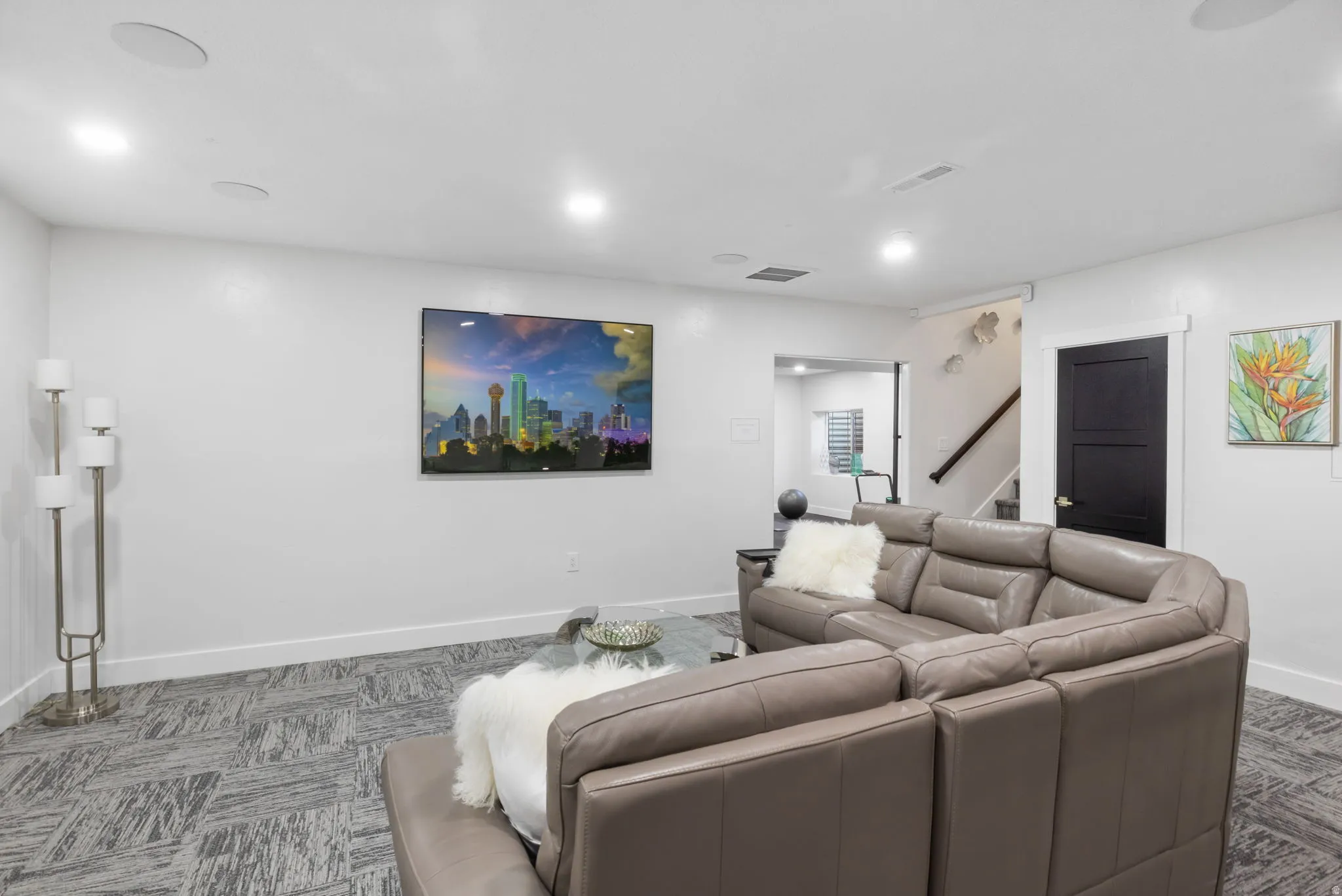 Living area with carpet and stairs
