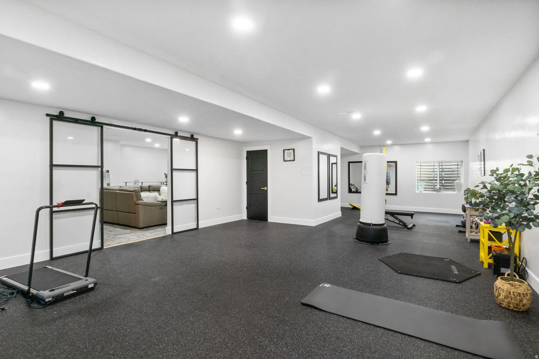 Workout area featuring a barn door and recessed lighting