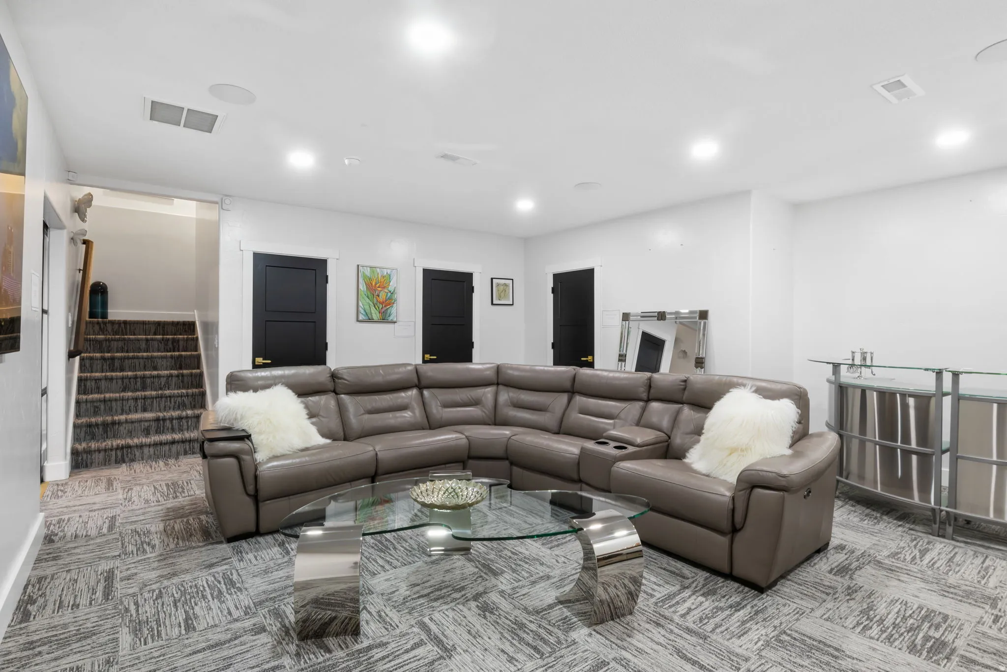 Living area featuring stairs and recessed lighting