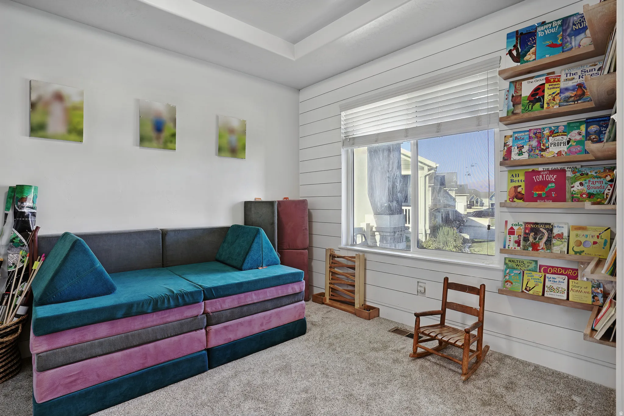 Living area featuring carpet and wood walls