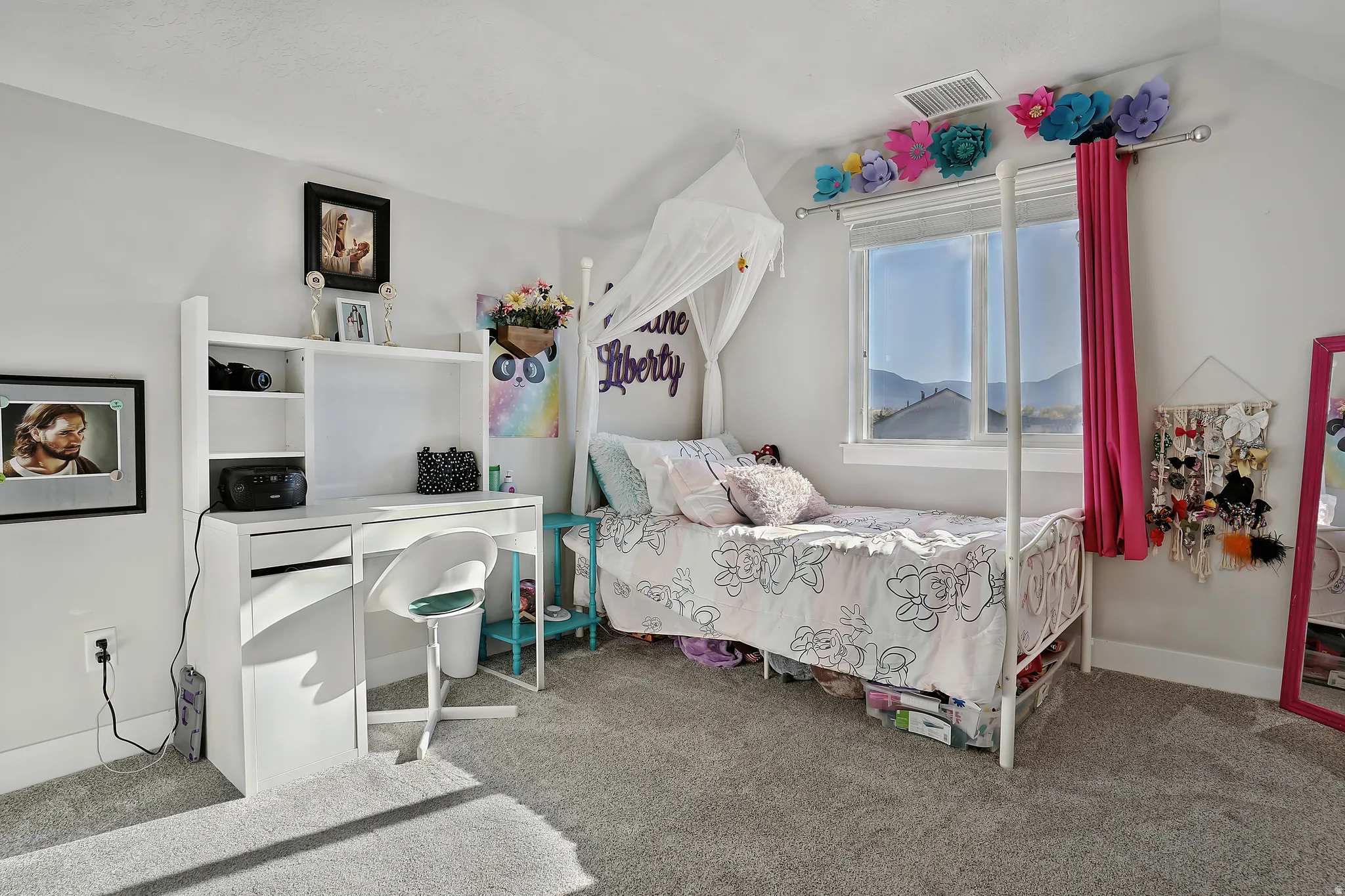Bedroom with carpet flooring and vaulted ceiling