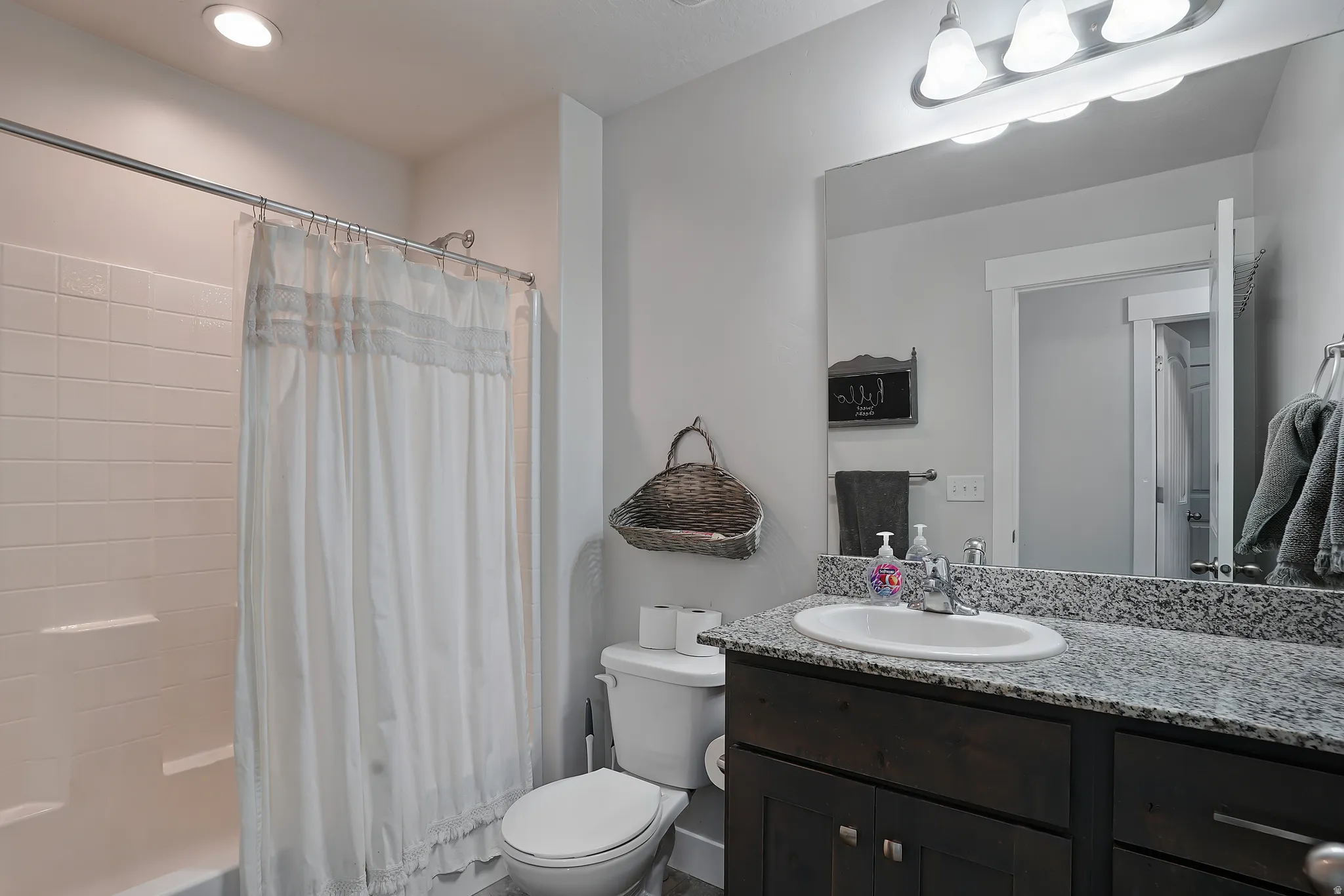 Full bath with shower / bath combo, vanity, and recessed lighting