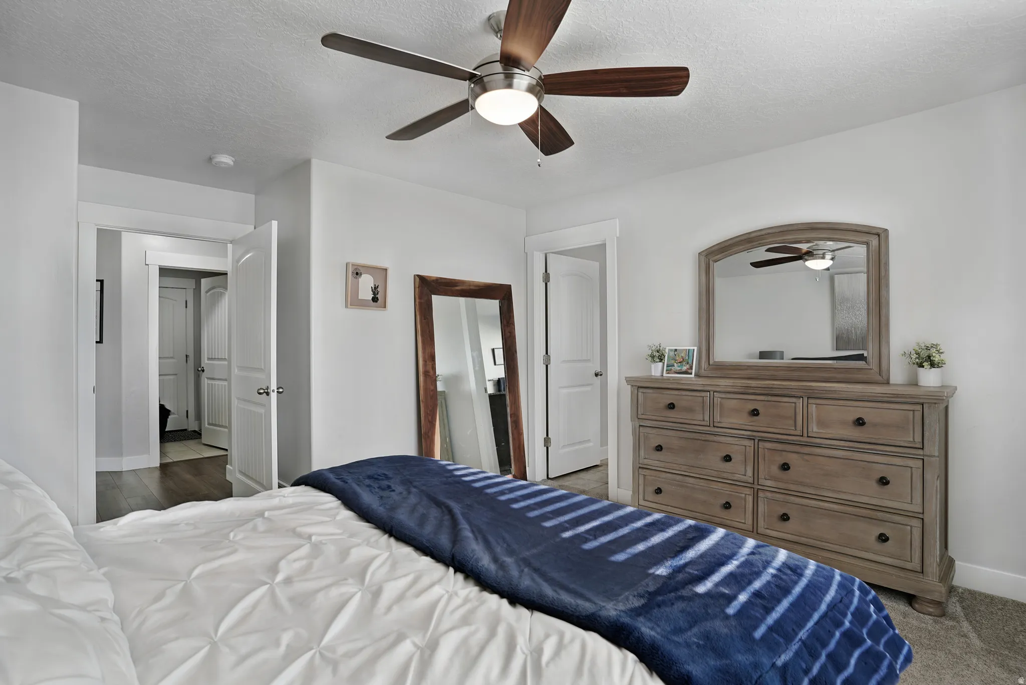 Bedroom featuring a textured ceiling and a ceiling fan