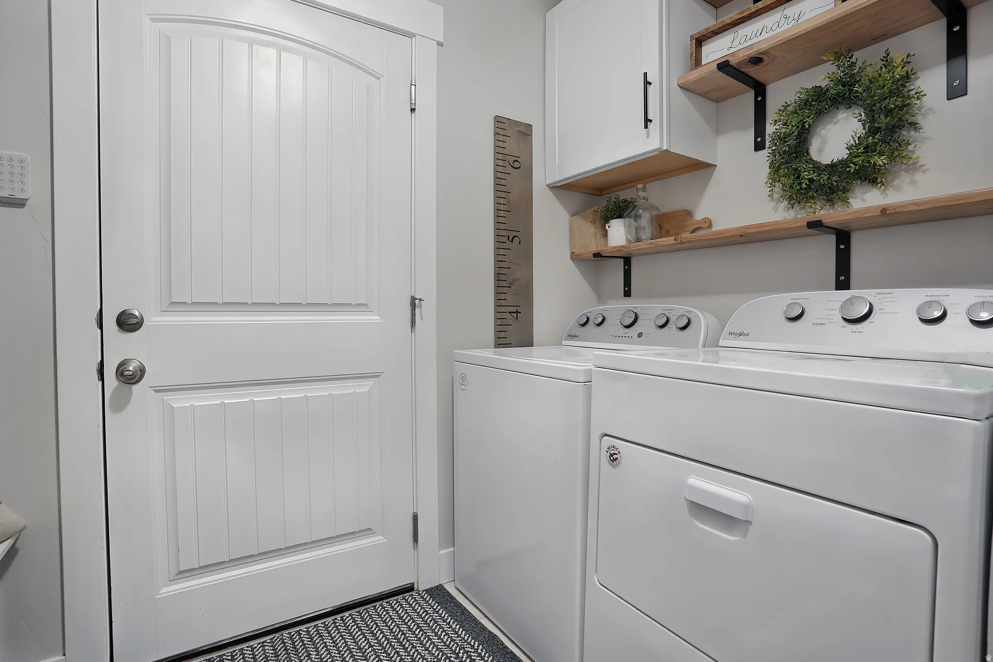 Washroom featuring washing machine and clothes dryer