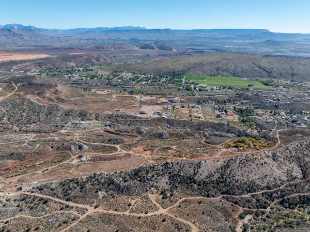 Aerial view of property's location with a mountainous background and rural landscape