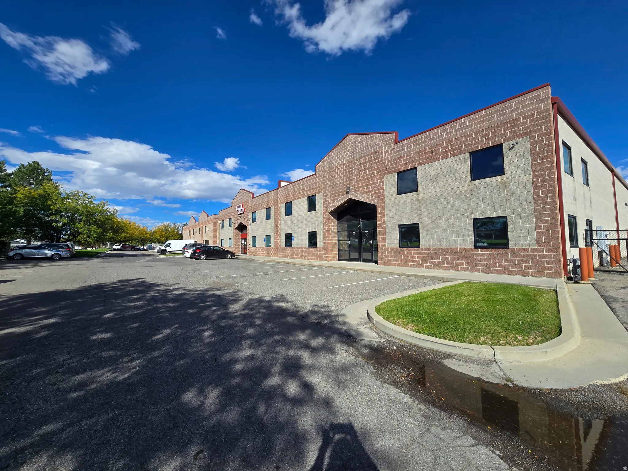 View of building exterior featuring uncovered parking