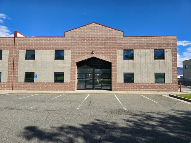 View of building exterior featuring uncovered parking
