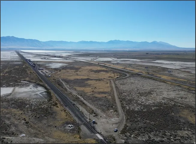 Aerial view of sparsely populated area featuring a mountain backdrop and a desert landscape