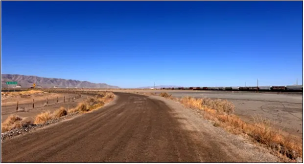 View of asphalt road featuring a rural view and a mountain view